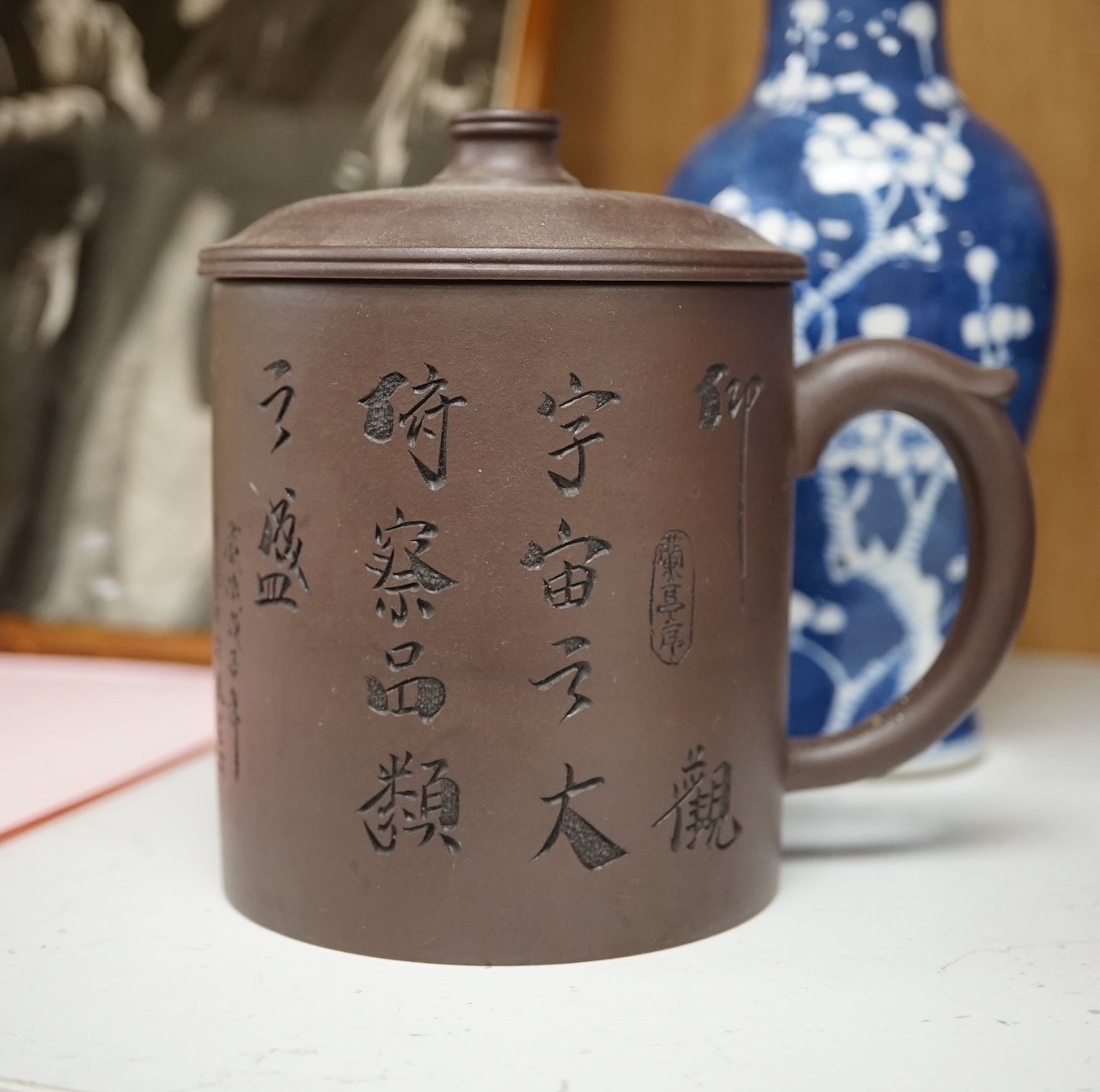 Two Chinese prunus jars and two vases, early 20th century, tallest 26cm, together with two Chinese Yixing pottery teapots, one Republic period, tallest 12.5cm. Condition - varies, poor to fair